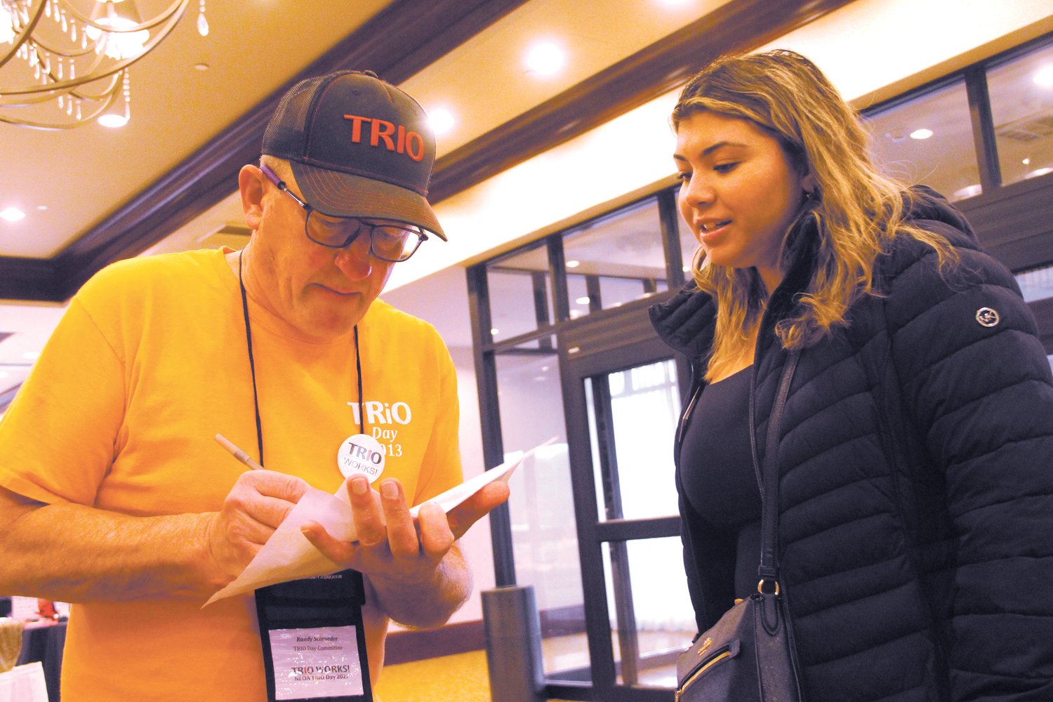 GETTING HER SQUARED AWAY:  Randy Schroeder, a member of the NEOA Board of Directors assists Semra Boluk in where she needs to set up as a representative for the University of Hartford.