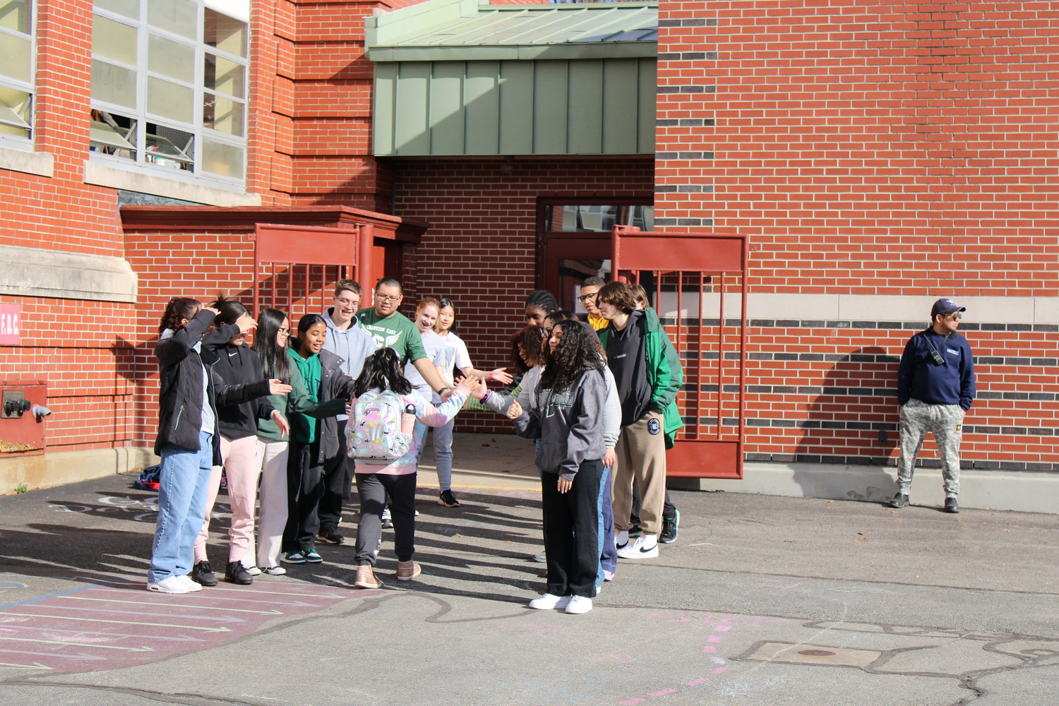 William Dutemple students are greeted by the boy’s and girl’s track teams from Cranston East as they get dropped off for school in the morning. (Photo by Ed Kdonian)
