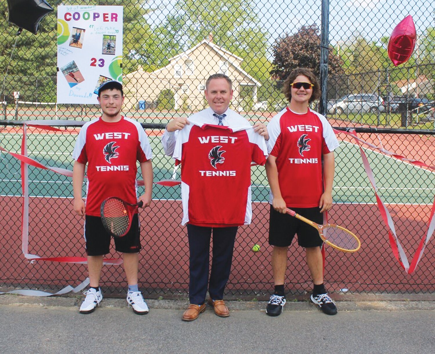 SENIOR CELEBRATION: Cranston West tennis senior captains Cooper Goodwin (left) and Liam McCormack (right) are joined by principal John Fontaine during the team’s Senior Night celebration. (Photos by Alex Sponseller)