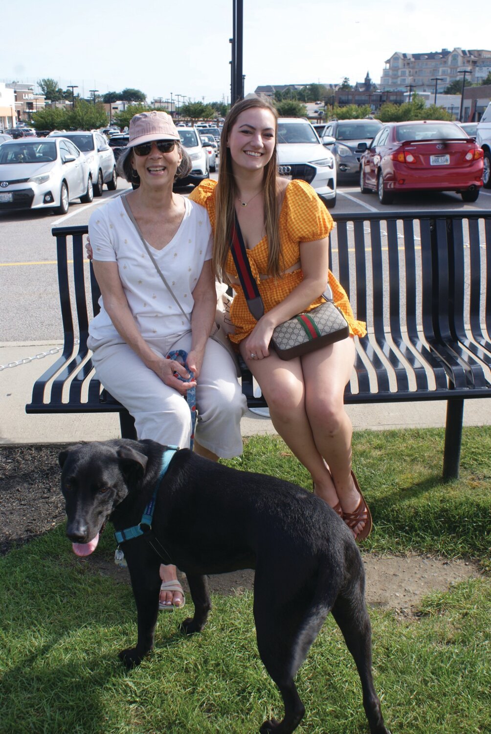 DIGGING IT WITH THE DOG: Beth Arruda (left) and daughter Laura Gagnon enjoy a day outside with with six-year-old black lab mix Ollie