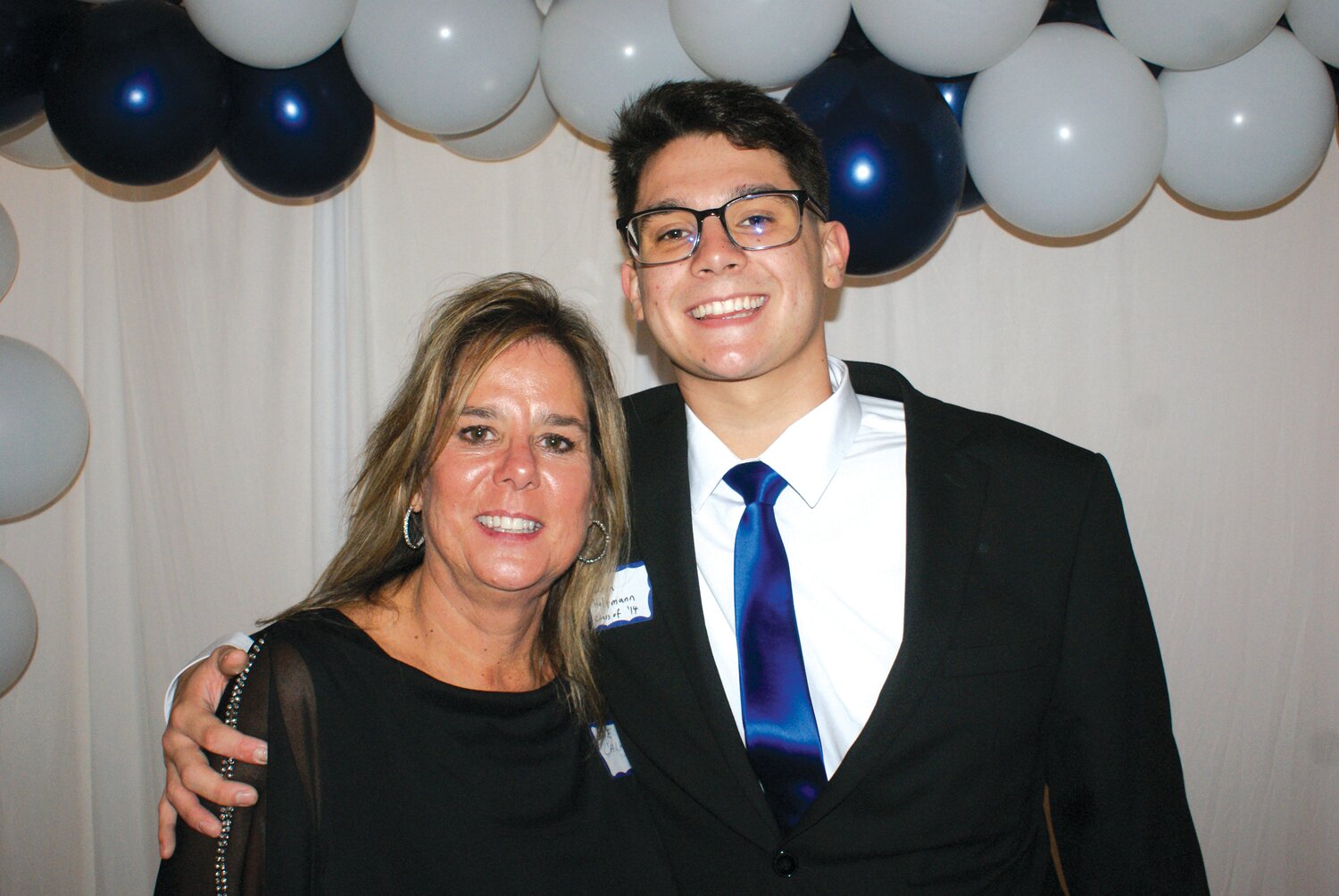 GENERATIONS: Mother Sue Calkins-Hoffmann, class of ‘78, and her son Jared Hoffmann, class of ’14, smile with pride as they celebrate the school that helped both of them prepare for adulthood. -