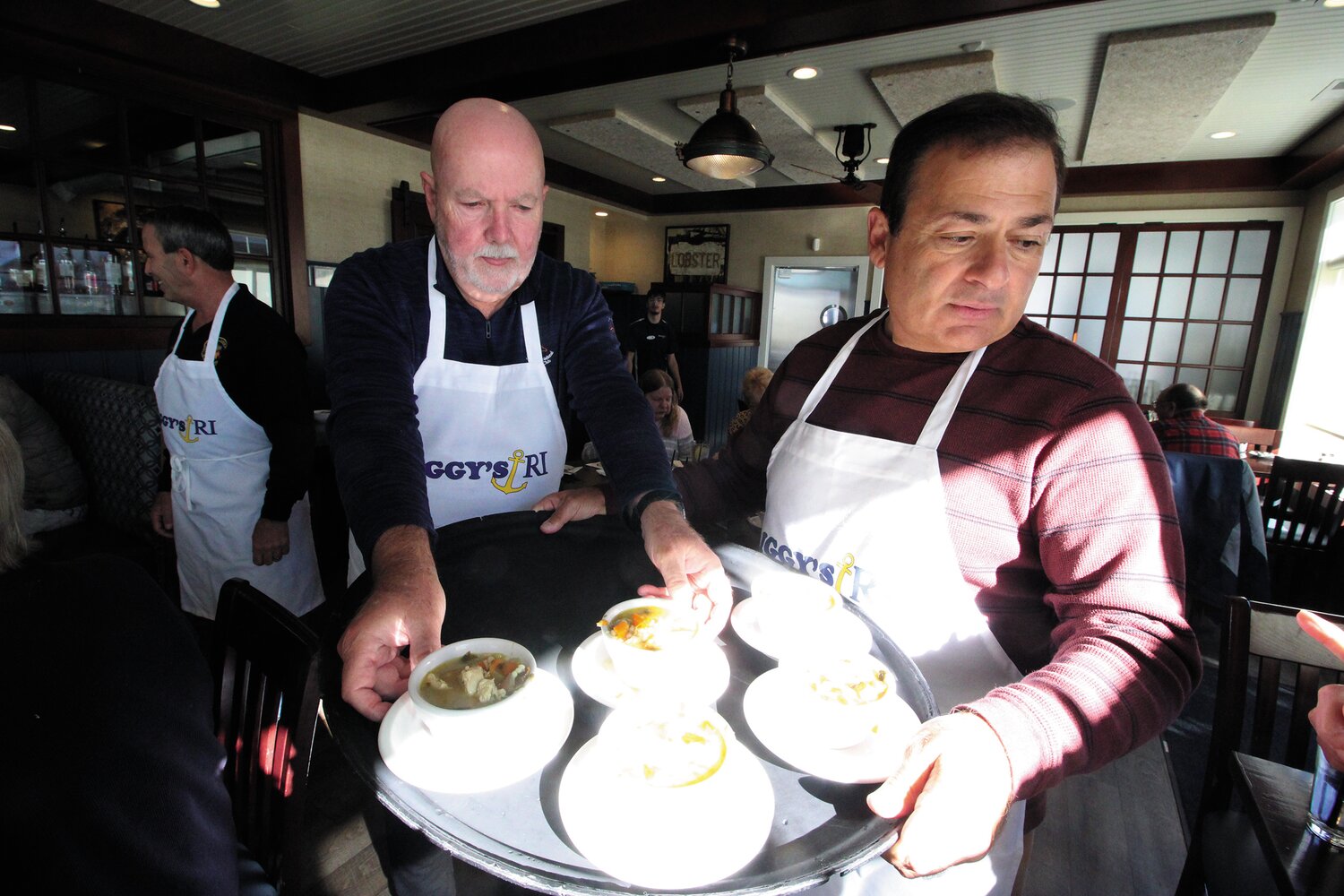 SOUP’S FIRST: Kevin Murphy and House Speaker K. Joseph Shekarchi serve up soup, the first course to a turkey dinner at Iggy’s Boardwalk.